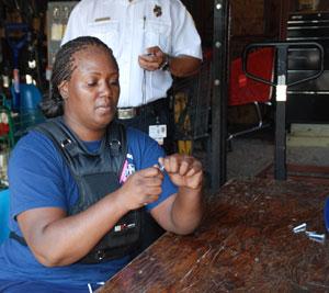 Image of a Fire Department employee assembling nuts and bolts.
