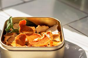 Photo of orange peels in a tin